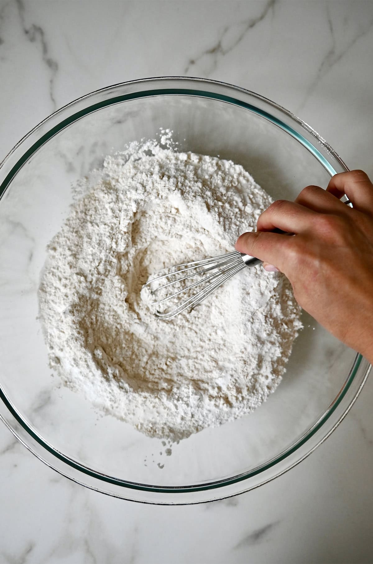 Whisking flour, baking powder, sugar and salt in a large bowl.