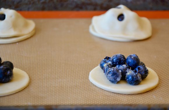 Blueberry hand pies unbaked and being assembled