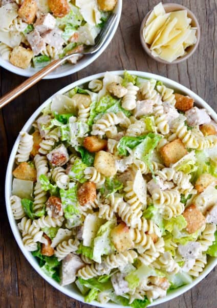 A top down view of a bowl containing the best Chicken Caesar Pasta Salad.
