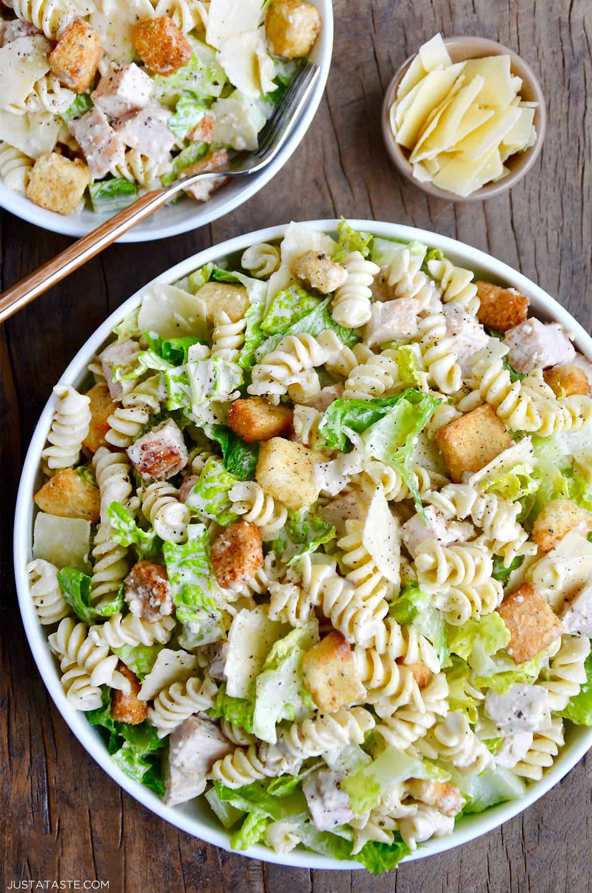 A top down view of a bowl containing the best Chicken Caesar Pasta Salad.