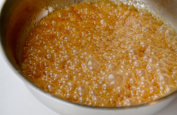 Saucepan containing boiling boozy caramel sauce