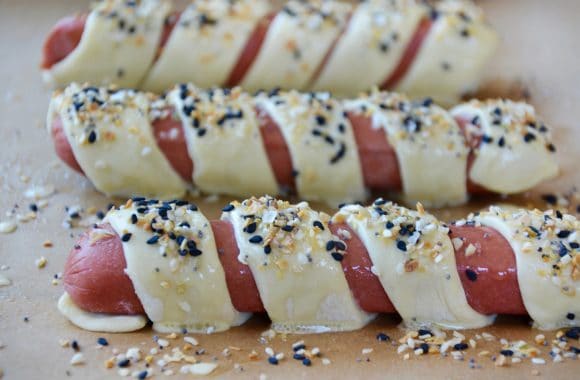 Hot dogs wrapped in puff pastry and sprinkled with everything seasoning