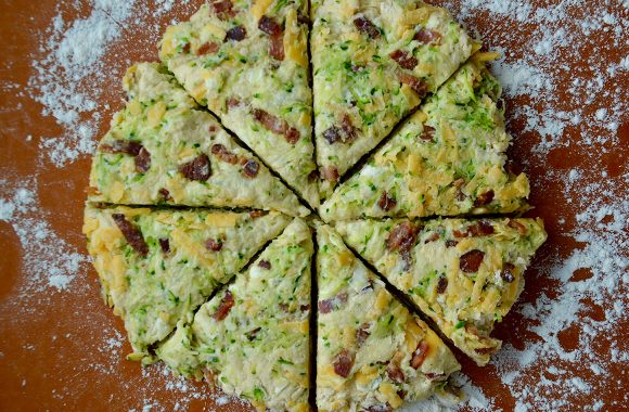 Savory scones on generously floured cutting board 