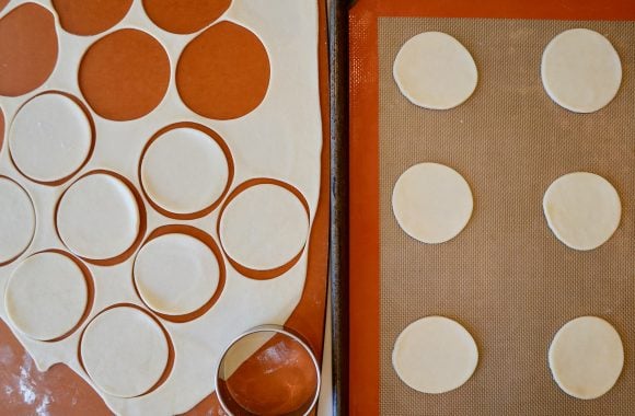 Pie dough rolled out and cut into small circles on a baking sheet