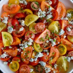 Top down view of Steakhouse Tomato Salad with Blue Cheese and chives