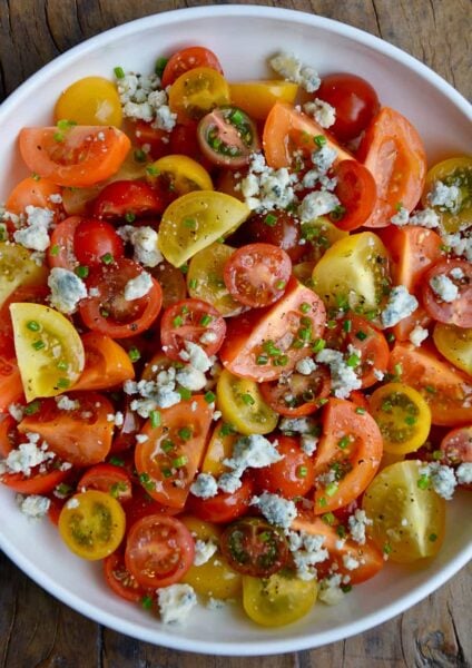 Top down view of Steakhouse Tomato Salad with Blue Cheese and chives