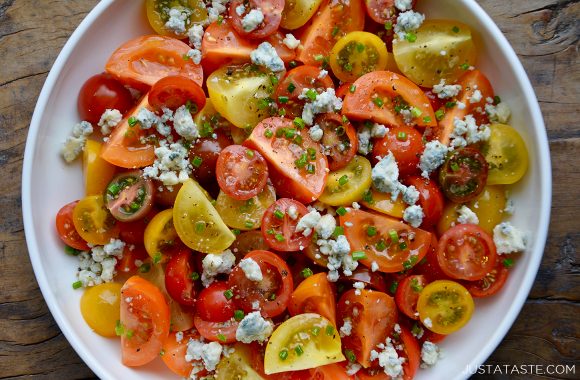 Steakhouse cherry tomato salad with blue cheese on white serving plate