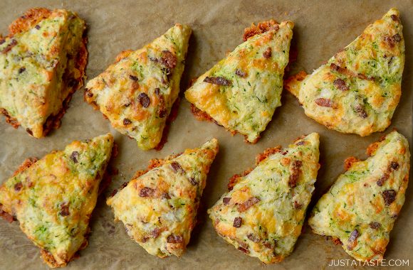 Top down view of the best homemade zucchini bacon cheddar scones on brown parchment paper