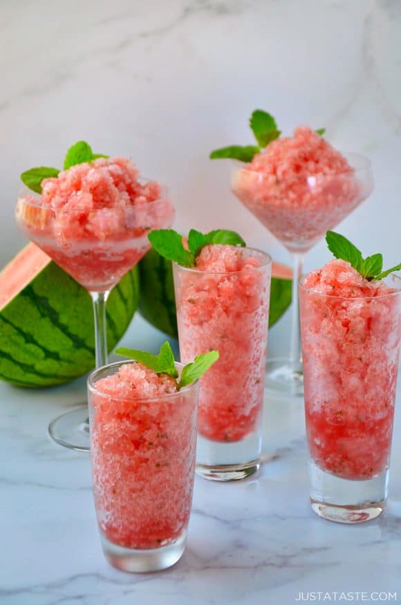 Various sized cocktail glasses filled with Boozy Watermelon Granita and fresh mint