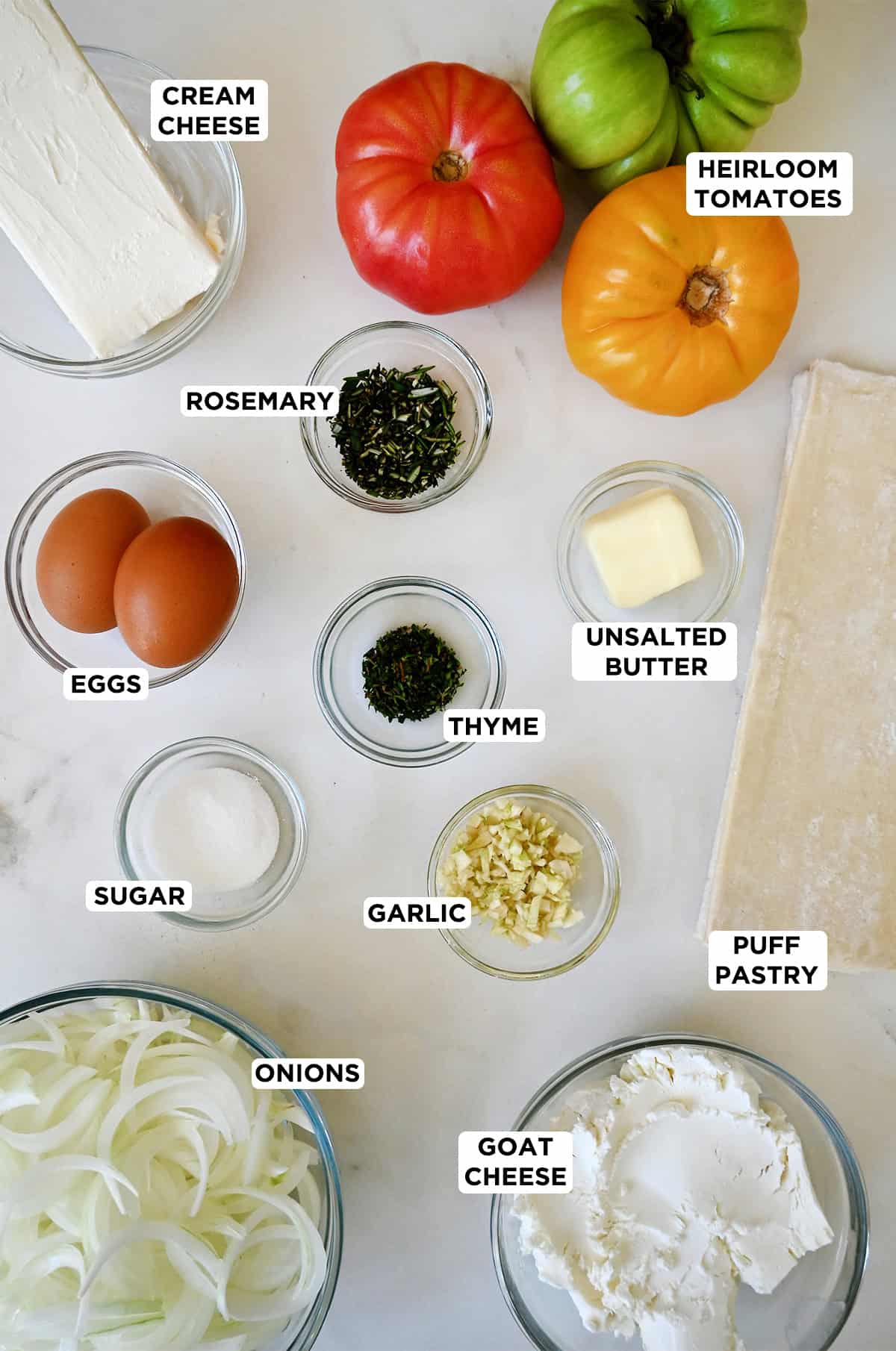 Ingredients to make a tomato tart with a savory onion cheese spread.