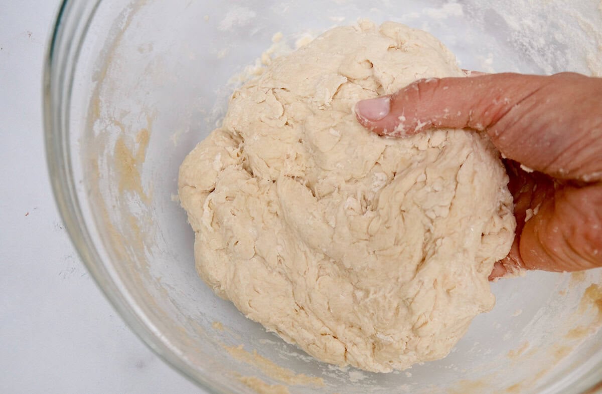 A glass bowl with tortilla dough.