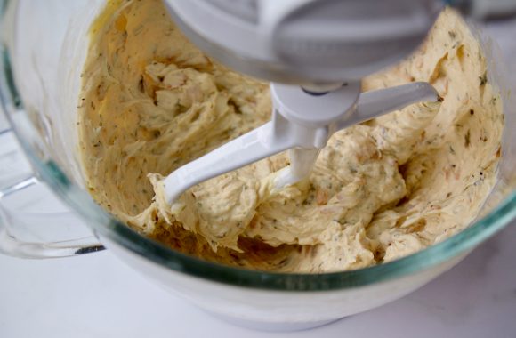 Stand mixer bowl containing cheese mixture