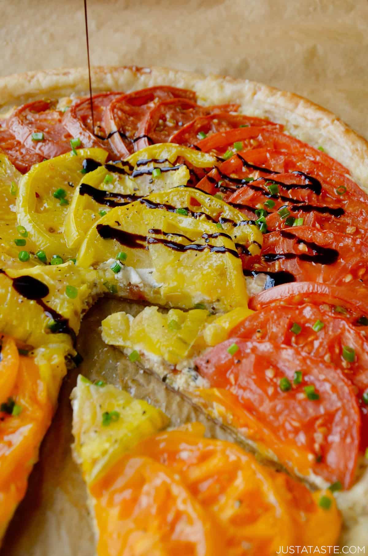 Puff pastry tomato tart drizzled with balsamic syrup and sprinkled with black pepper and flaky sea salt.