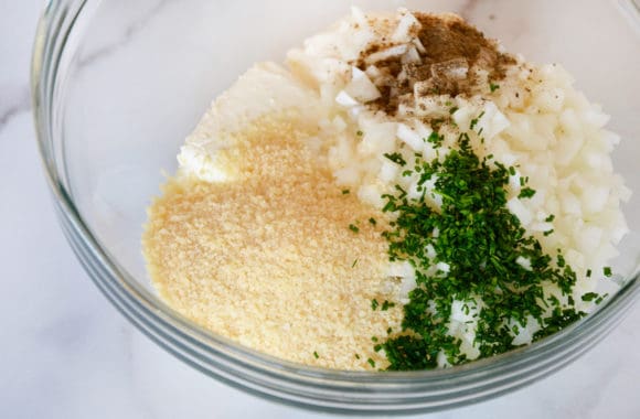 A glass bowl containing ingredients for making Crack Dip