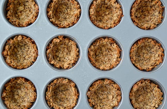 Top down view of freshly baked muffin tin filled with granola