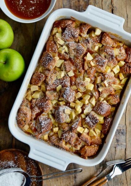A white serving dish containing freshly baked Caramel Apple Bread Pudding