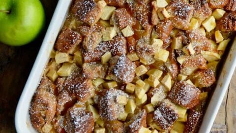 A white serving dish containing freshly baked Caramel Apple Bread Pudding