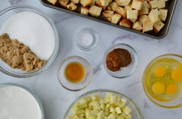 Small glass bowls containing ingredients for Caramel Apple Bread Pudding