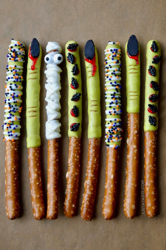 Chocolate Halloween Pretzels lined up on brown parchment paper