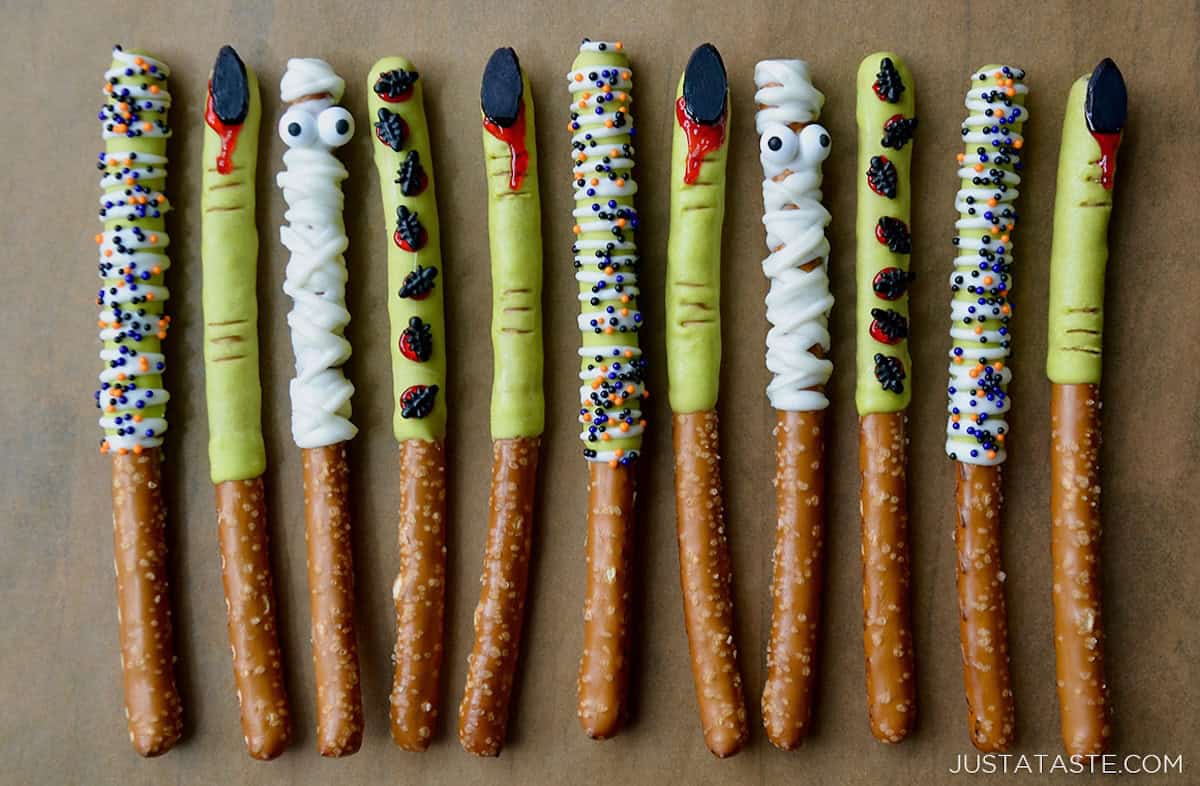 A line of Chocolate Halloween Pretzels on brown parchment paper.
