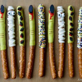 A line of Chocolate Halloween Pretzels on brown parchment paper