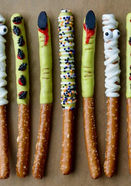A line of Chocolate Halloween Pretzels on brown parchment paper