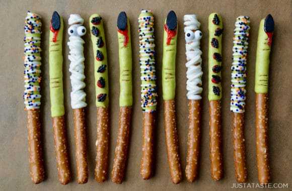 A line of Chocolate Halloween Pretzels on brown parchment paper