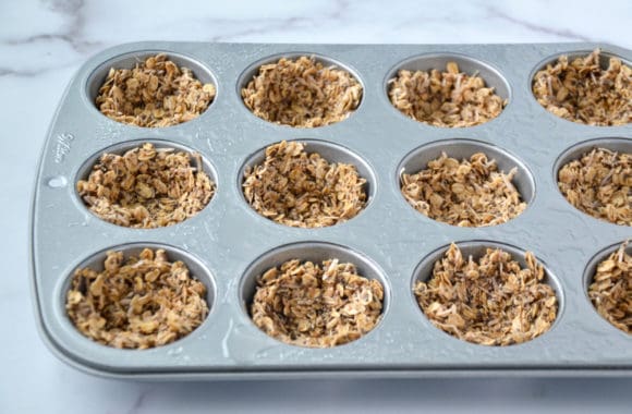 Closeup of muffin tin with unbaked granola 