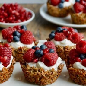 Muffin Tin Granola Cups topped with yogurt and fresh fruit