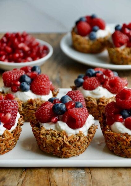 Muffin Tin Granola Cups topped with yogurt and fresh fruit