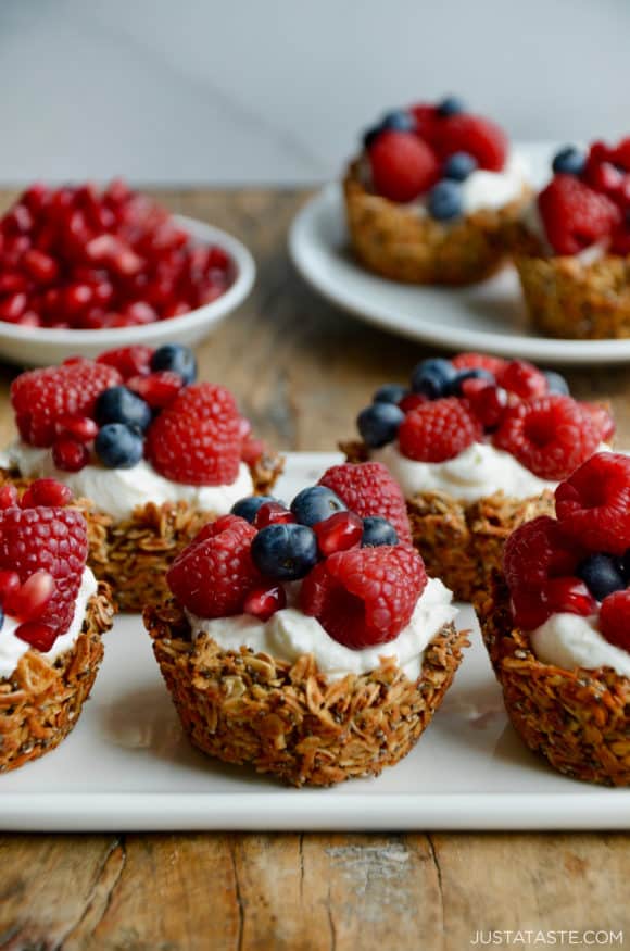 Cups of granola topped with yogurt and fresh fruit