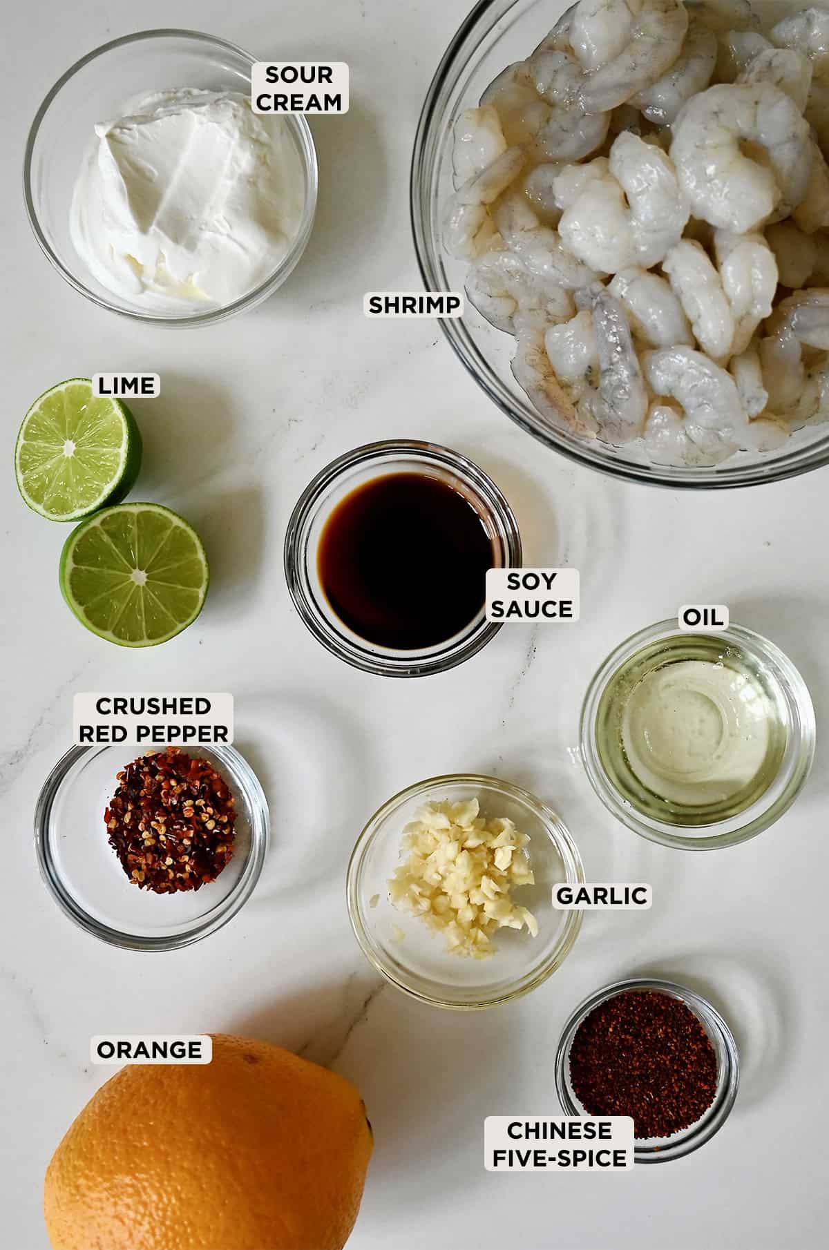 Ingredients to make shrimp tacos with lime crema.