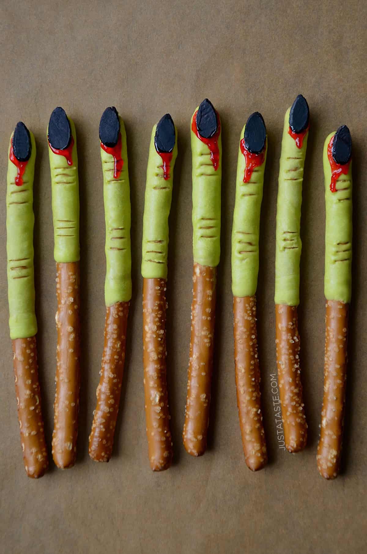 Witches finger pretzels - pretzel rods that have been dipped into green candy melts and given almond 'fingernails' that are 'bleeding'. 