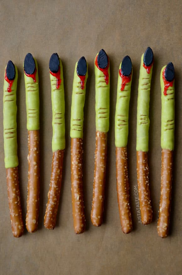 A line of bloody witches' finger pretzels dipped in green chocolate