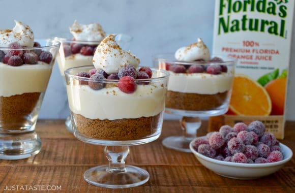 Glass parfait glasses with cheesecake and sugared cranberries