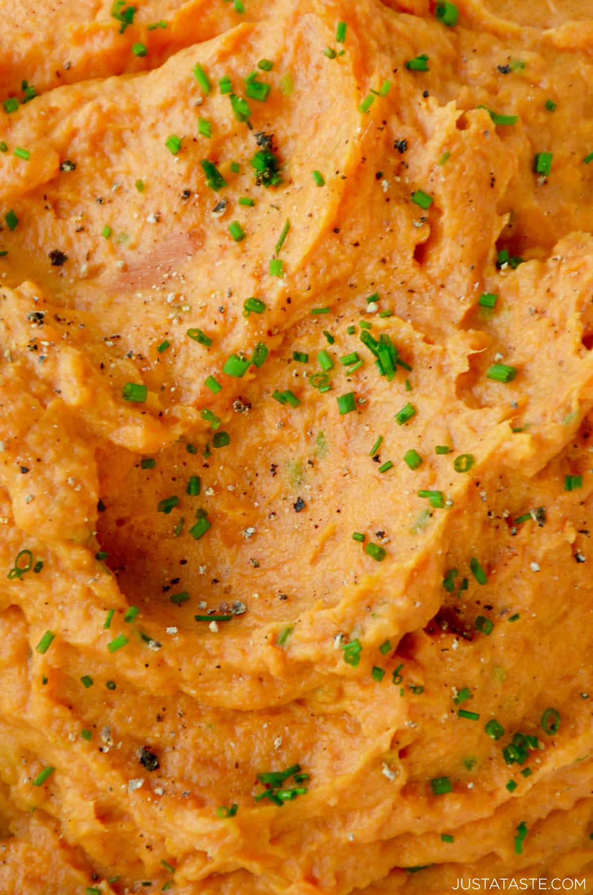 Mashed sweet potatoes garnished with fresh chives, salt and pepper.