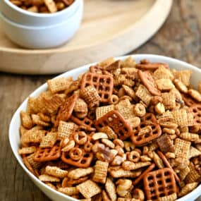 Homemade Chex Mix in a white serving bowl.