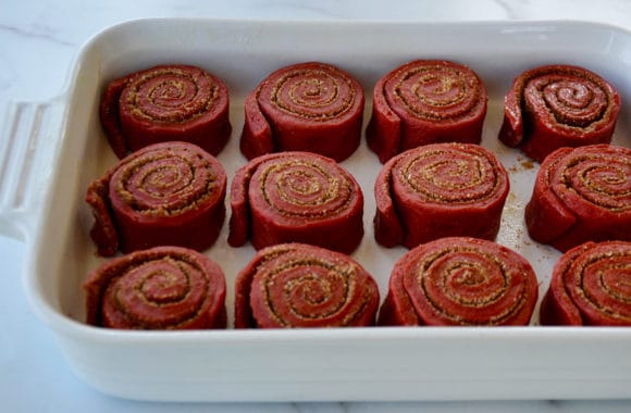 A white baking dish filled with unbaked cinnamon rolls