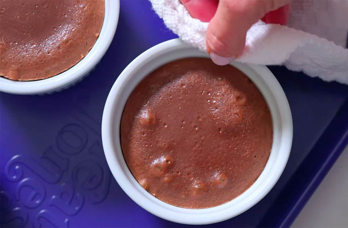 Freshly baked lava cake in a ramekin.