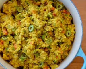 Dutch oven containing Chicken and Yellow Rice with sliced green olives