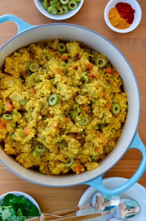 Dutch oven containing Chicken and Yellow Rice with sliced green olives