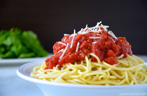 Bowl of spaghetti topped with 10-minute homemade marinara sauce and shredded parmesan cheese