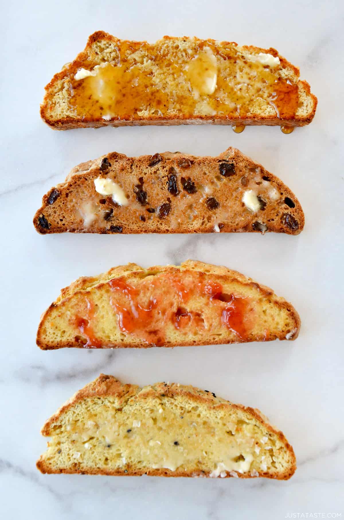 Four slices of toasted no yeast bread topped with different toppings