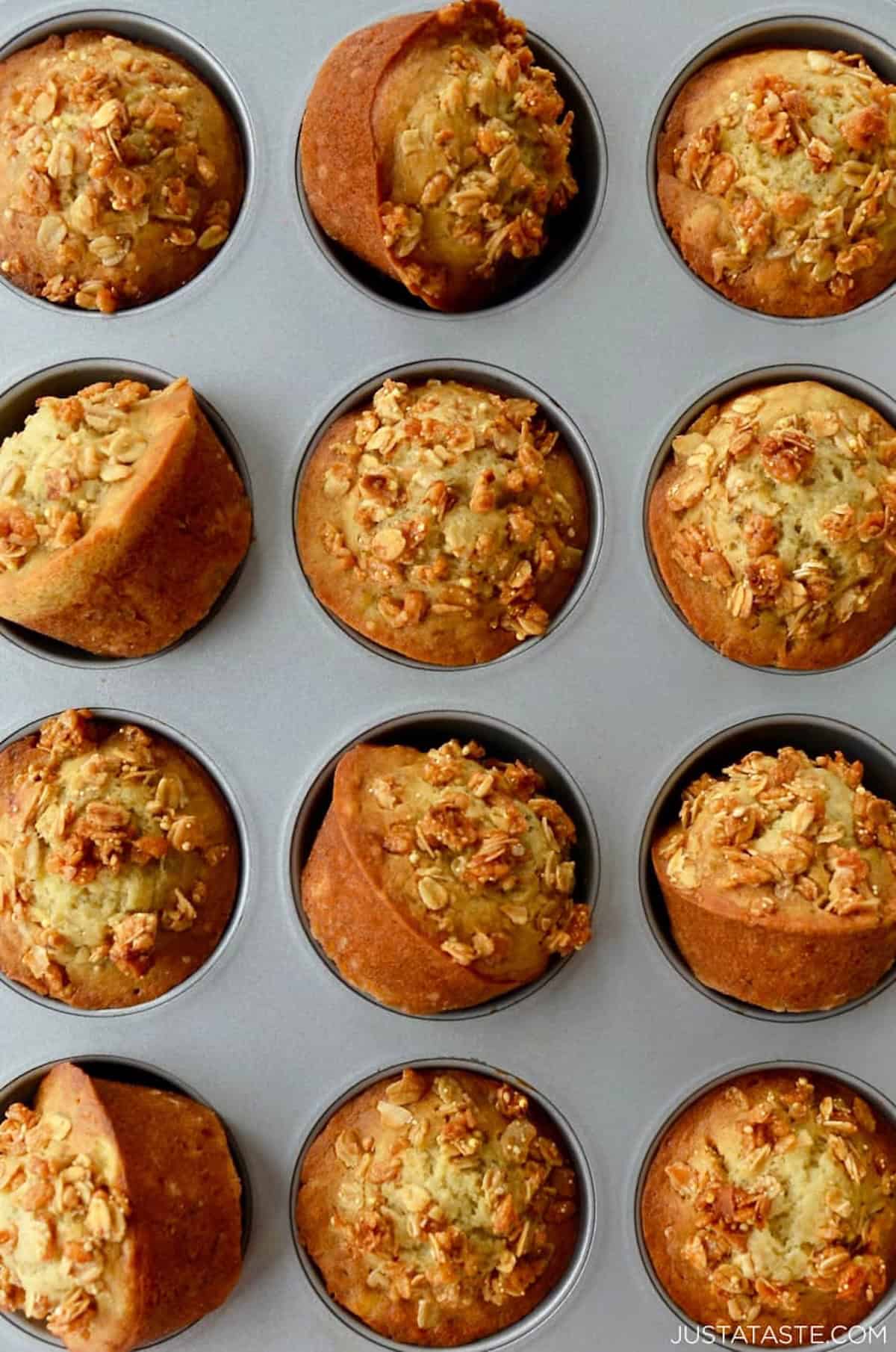 Moist banana granola muffins in a muffin tin.