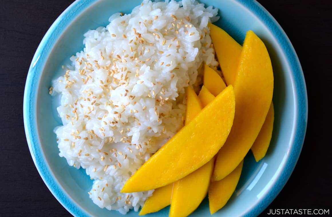 Thai Coconut Sticky Rice with sliced mango on blue plate