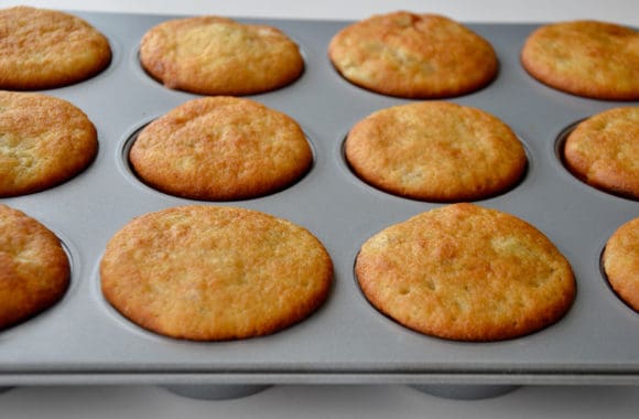 Muffin pan containing freshly baked cupcakes