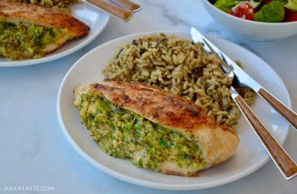 A white dinner plate containing a chicken breast and wild rice