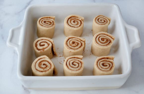 Unbaked cinnamon rolls arranged in a baking dish