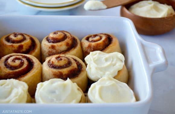 No-yeast cinnamon rolls in a baking dish with half of them frosted