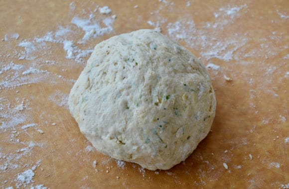 Ball of dough on flour-covered work surface 